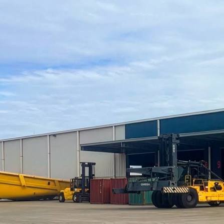 Shipping containers and loading equipment at a logistics yard